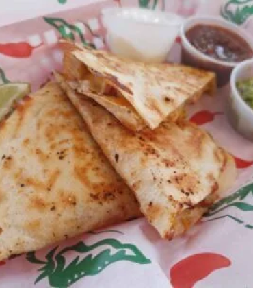 Quesadillas with guacamole and guacamole on a plate.