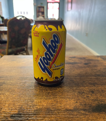 A can of yohoo sitting on a table.