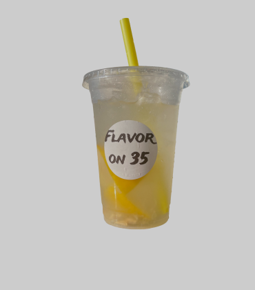 A cup of lemonade with a yellow straw.