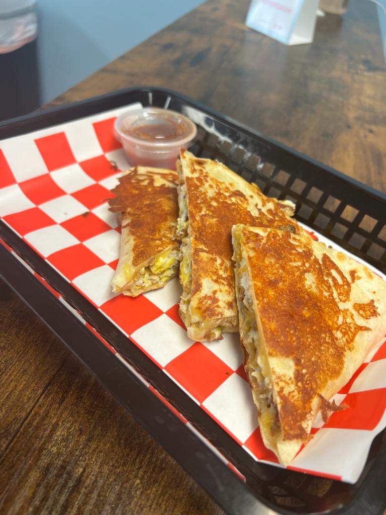 Quesadillas on a tray on a table.